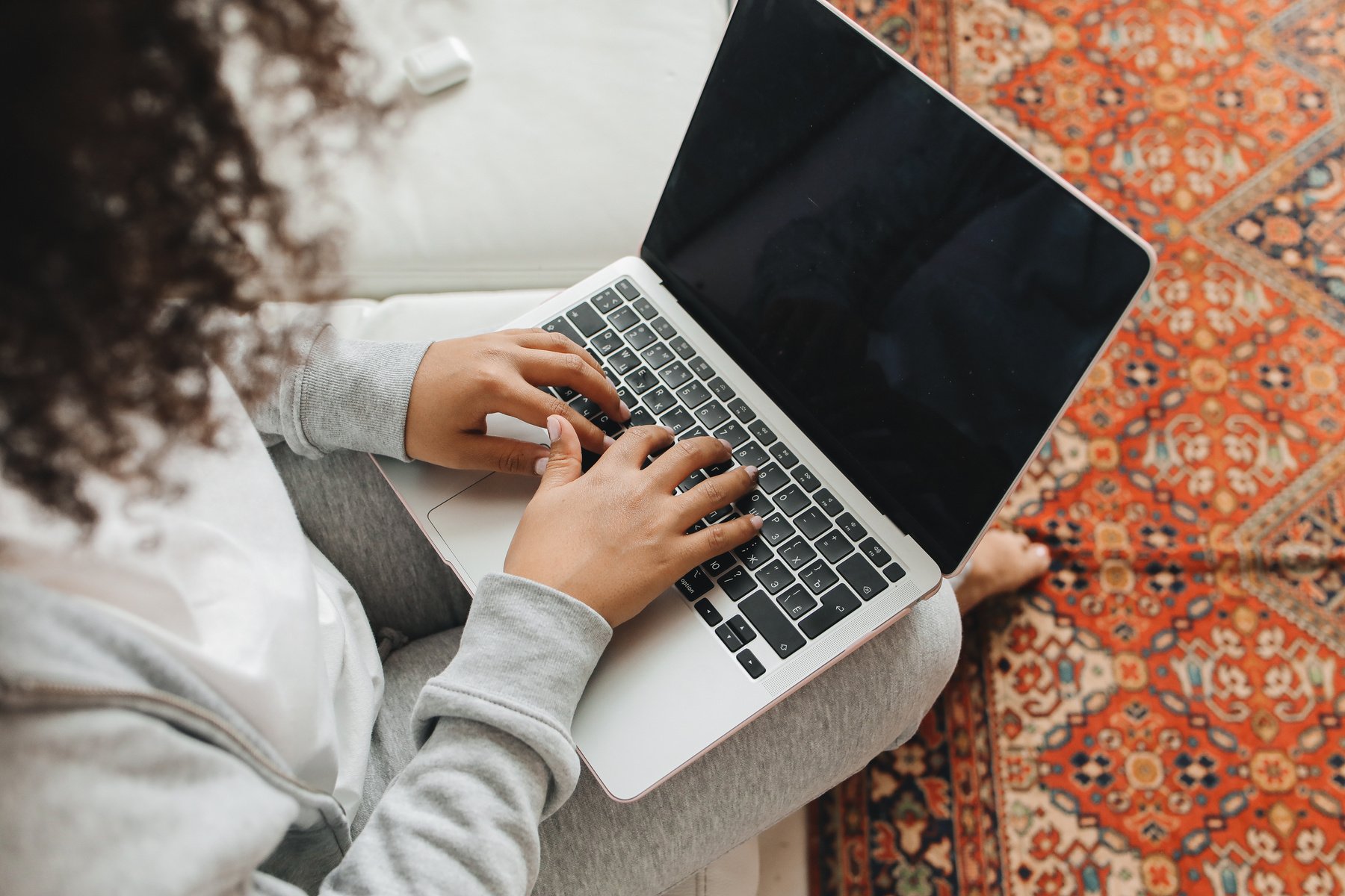 A Woman Typing on a Laptop